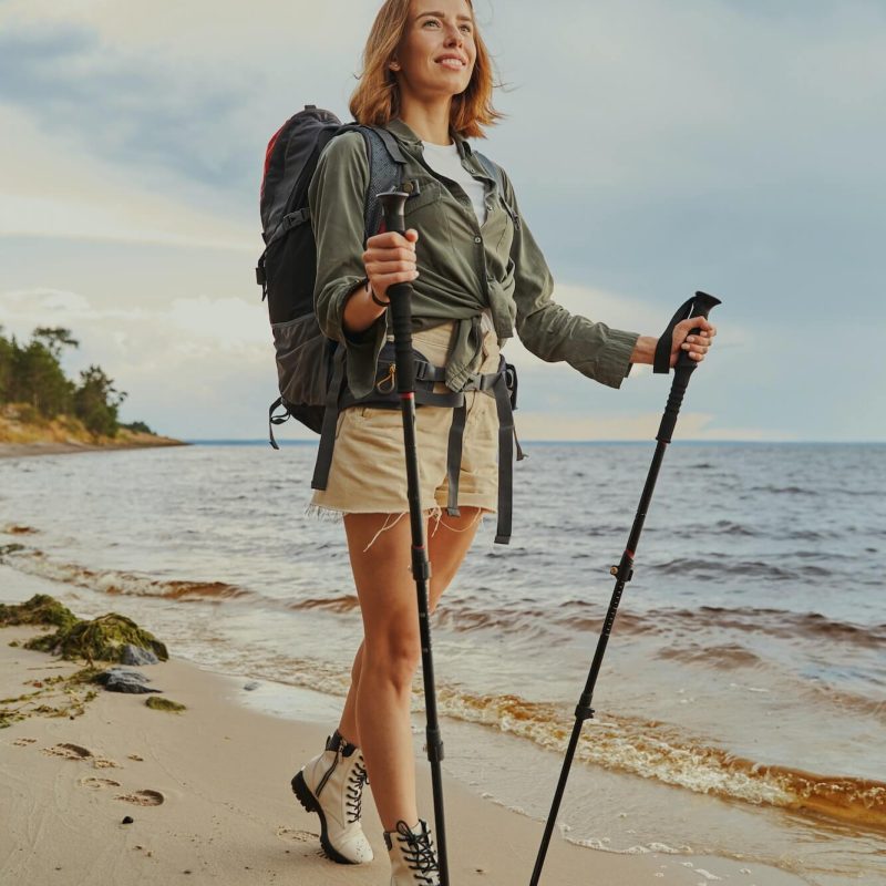 optimistic-traveller-using-walking-poles-during-beach-stroll-1.jpg